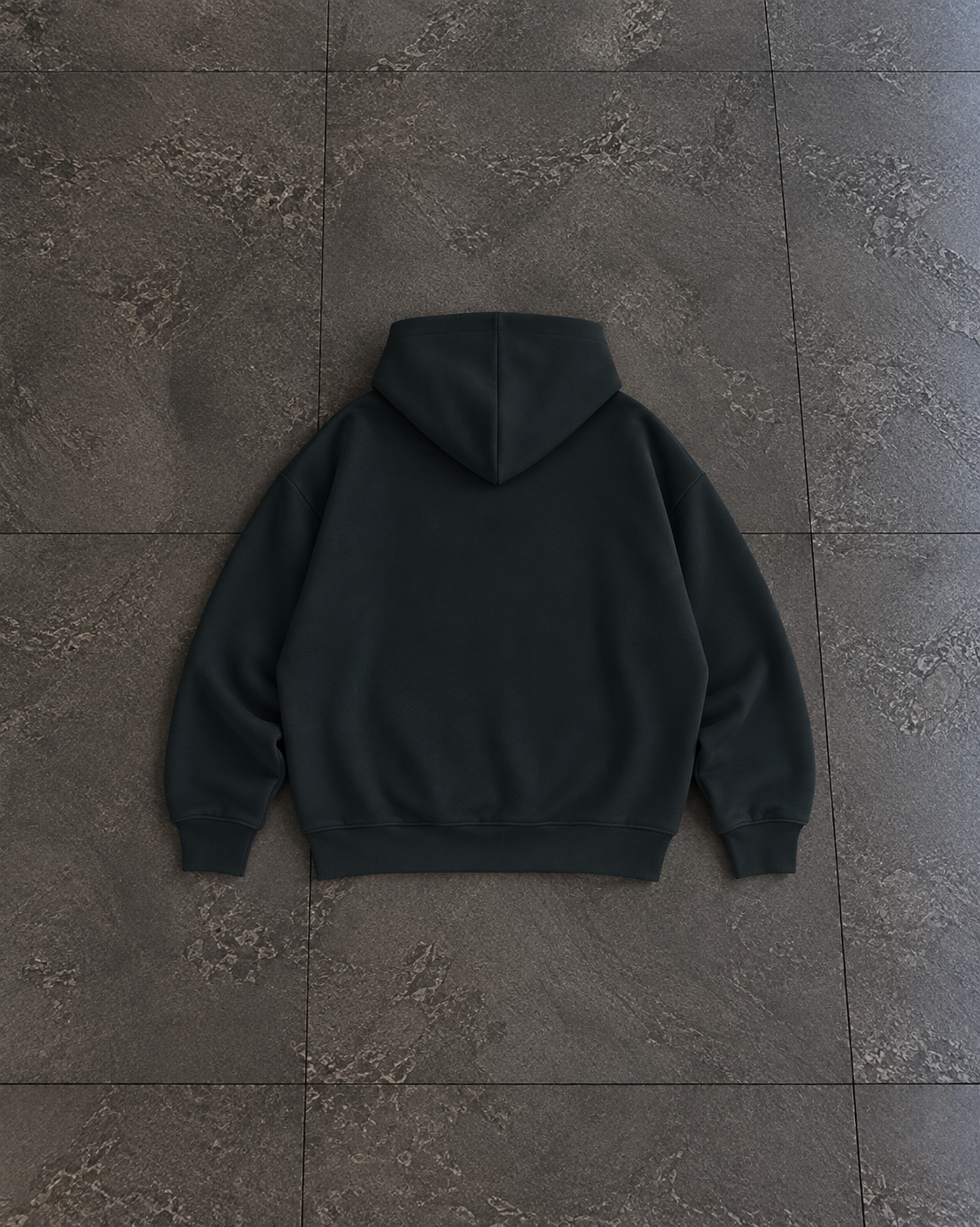 A dark charcoal gray hoodie shown from the back, laid flat on a textured dark gray tiled floor.

Color: Black Back