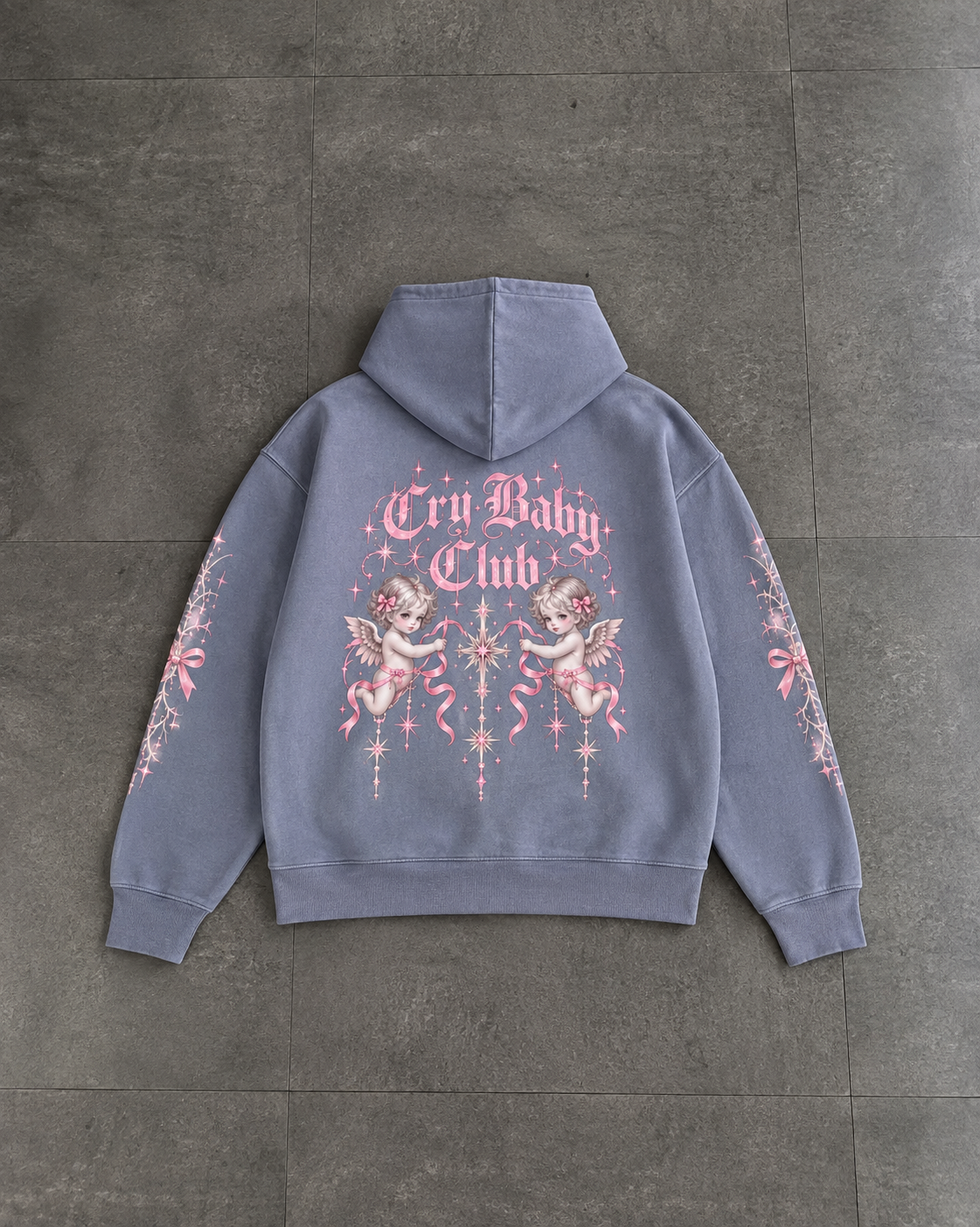 A light periwinkle blue hoodie shown from the back, featuring a pink and white graphic print with cherubs and the text 'Cry Baby Club' on a dark gray tiled floor.

Color: Dyed Blue Grey Back
