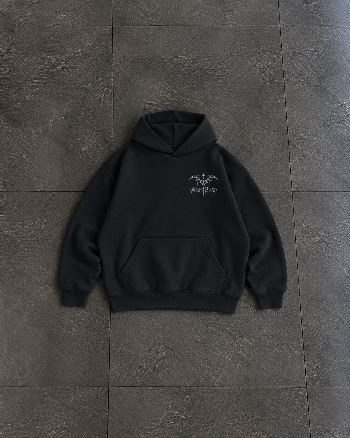 A black pullover hoodie with a small white graphic on the left chest, laid flat on a dark gray tiled surface.

Color: Black Front 