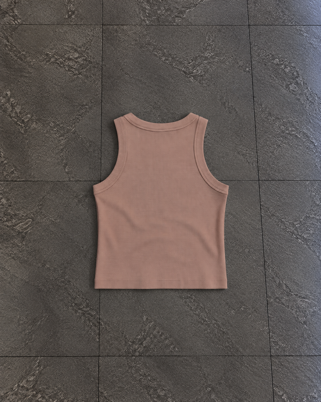 A sleeveless ribbed tank top in a dusty rose or mauve color, laid flat on a dark gray textured tile floor.

Color: Hazy Pink Back