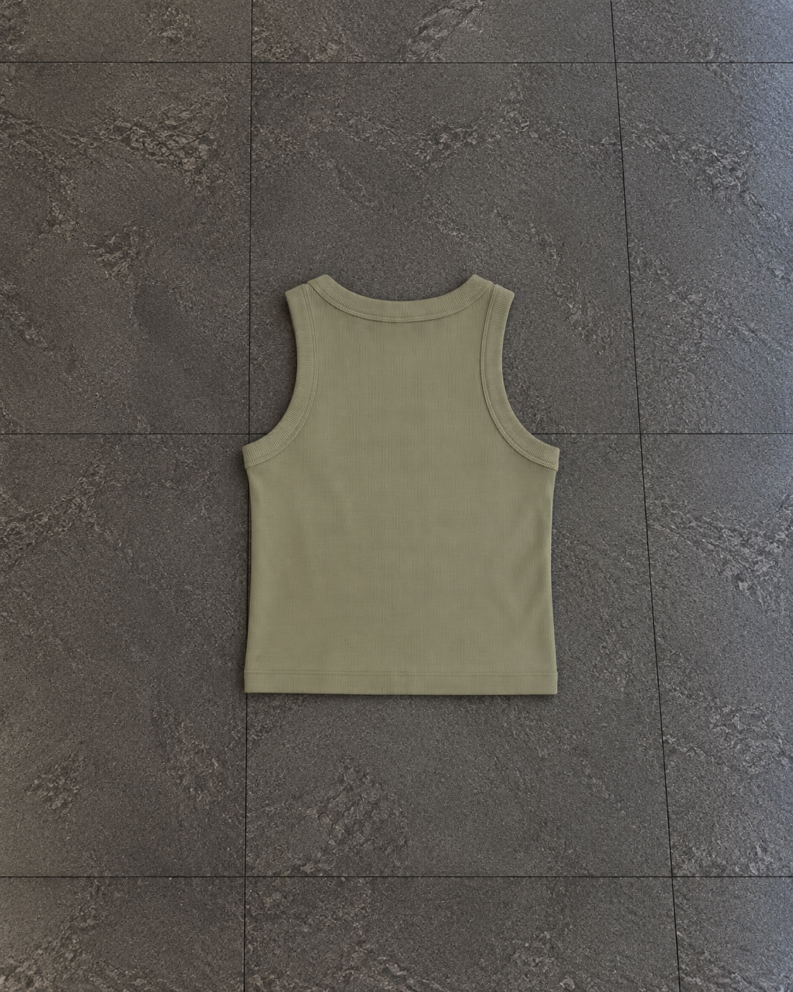 A sleeveless ribbed tank top in a muted sage green color, laid flat on a dark gray tiled floor.

Color: Eucalyptus Back